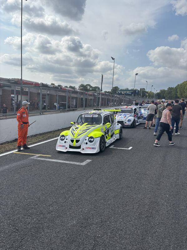 Fun Cup cars lined up under a cloudy sky