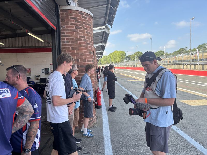 The media crew with cameras in the pit lane