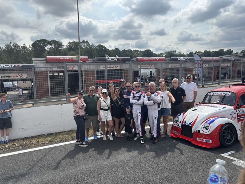 Team members and guests lined up with Car 146 for a team photo